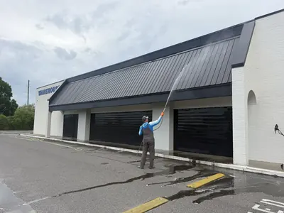 ProWash360 crew pressure washing the front of a commercial building
