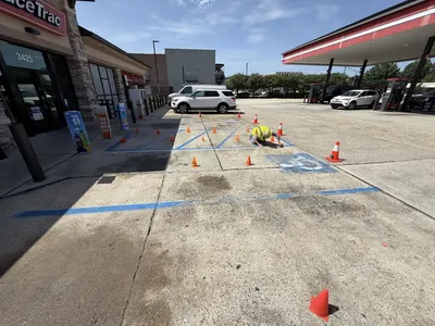 ProWash360 crew laying out new parking stall and ADA striping at a gas station