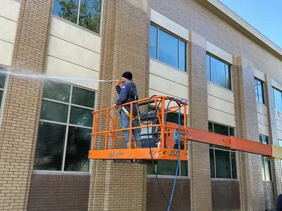 Washing a three-story office building from a lift