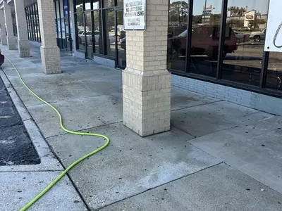 Freshly washed walkway and columns in front of a row of storefronts