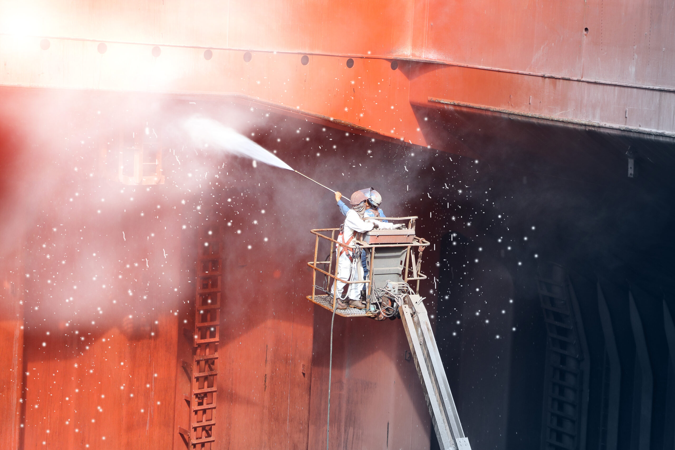 High pressure water jet to cleaning with Old ship washing on Trucks have sherry piker, worker wear equipment protective safety harness and PPE in cargo hold of cargoship.